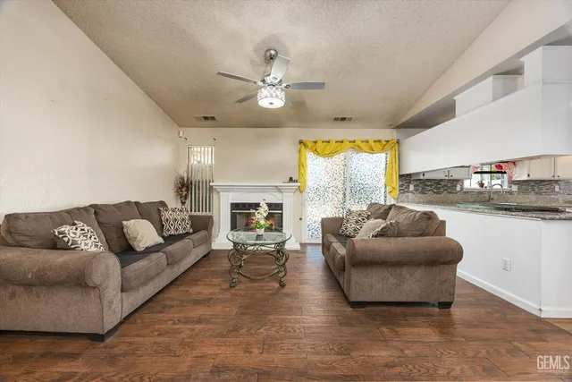 a living room with furniture and a fireplace