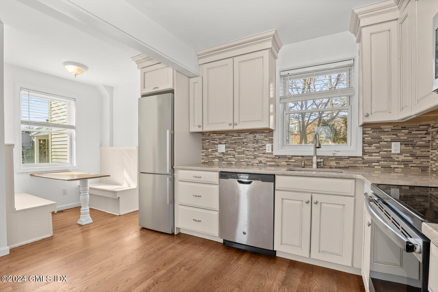 71 Old Field Point Road Greenwich, CT 06830 - Photo 7 of 23 a kitchen with white cabinets and white appliances