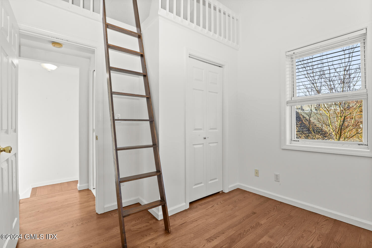 71 Old Field Point Road Greenwich, CT 06830 - Photo 10 of 23 a view of an empty room with wooden floor and a window
