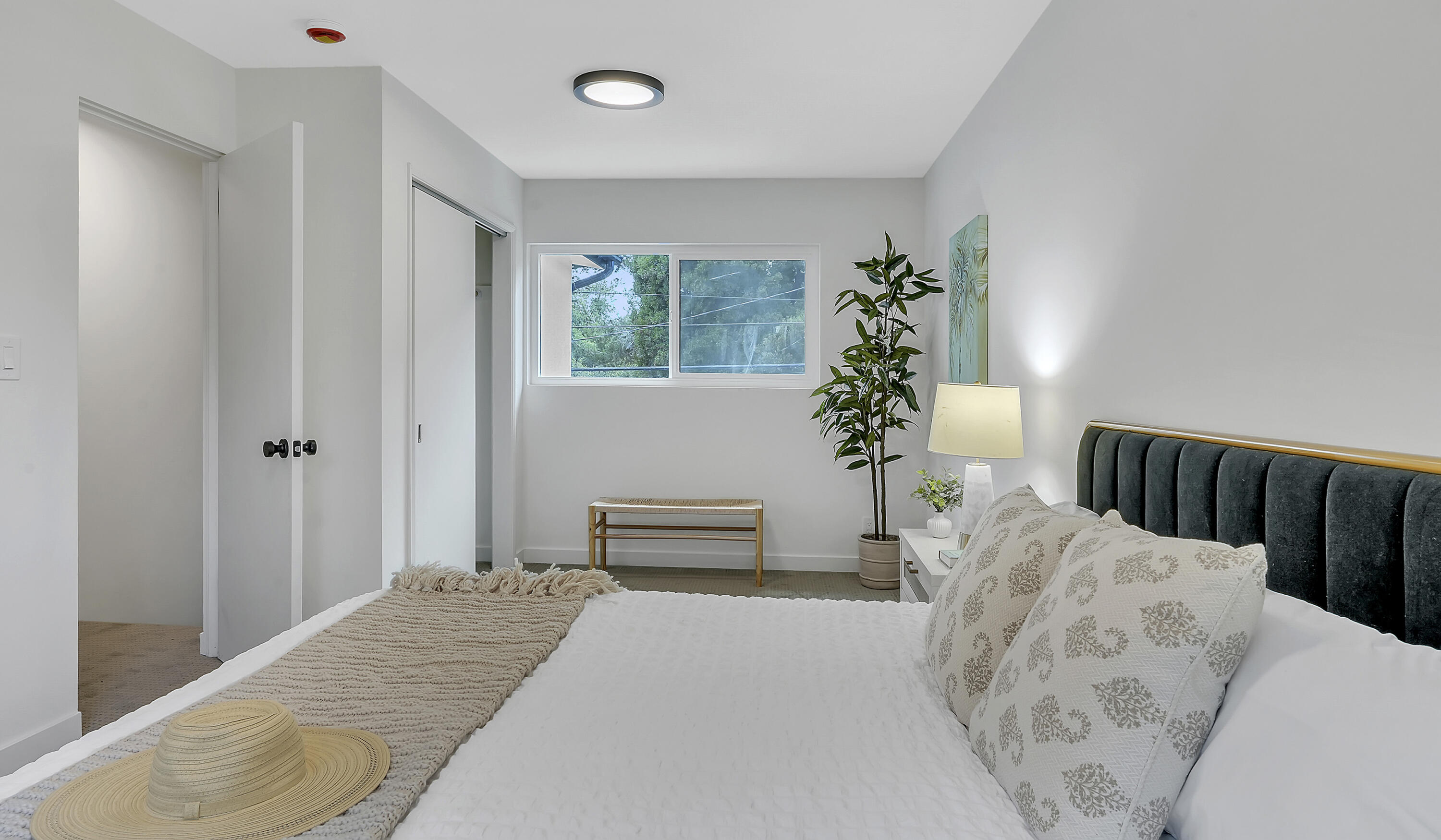1708 Castillo Street Santa Barbara, CA 93101 - Photo 18 of 19 a bedroom with a bed and a potted plant