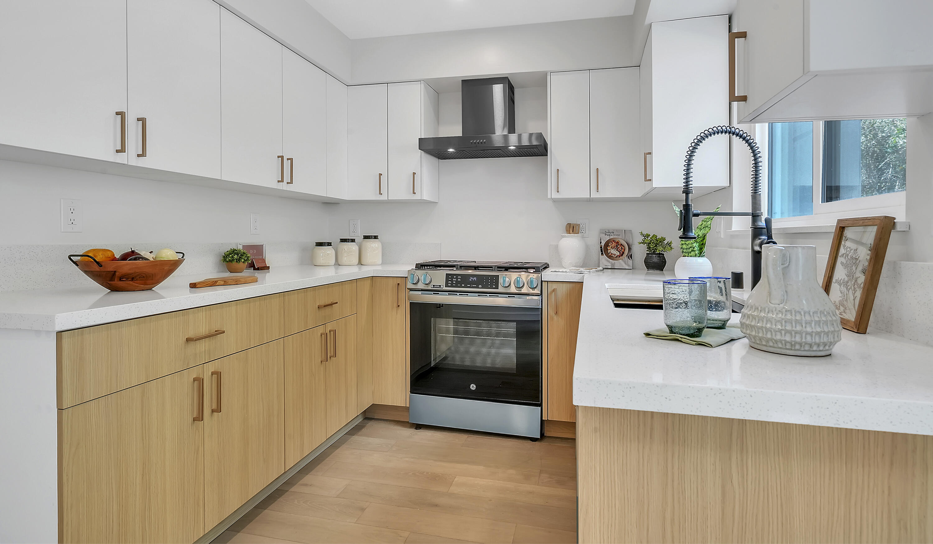 1708 Castillo Street Santa Barbara, CA 93101 - Photo 3 of 19 a kitchen with stainless steel appliances granite countertop a stove a sink dishwasher and white cabinets with wooden floor