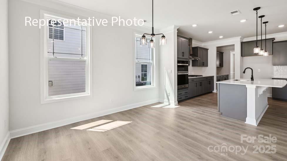7633 Bainbridge Road Sherrills Ford, NC 28673 - Photo 12 of 34 a kitchen with stainless steel appliances kitchen island granite countertop a refrigerator and a sink