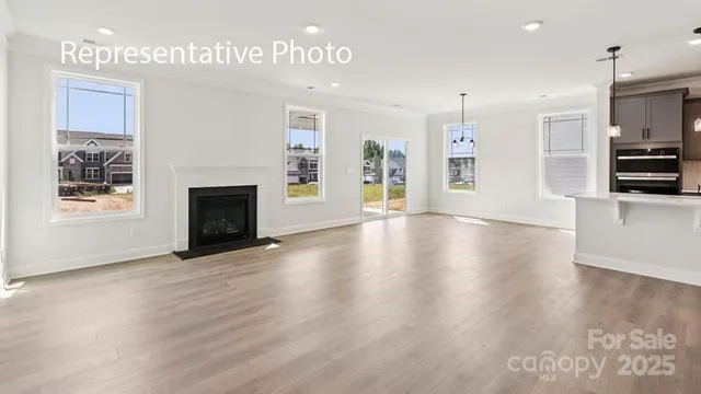 a view of an empty room with window and fire place