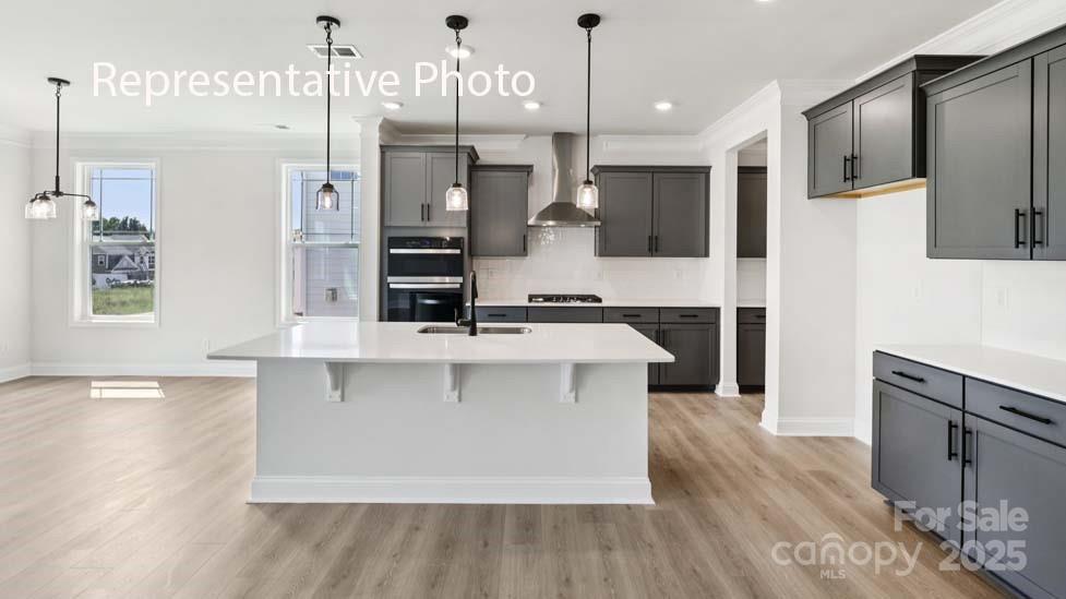 7633 Bainbridge Road Sherrills Ford, NC 28673 - Photo 9 of 34 a large kitchen with stainless steel appliances a large center island attached withe living room