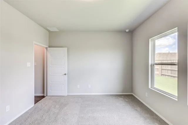 a view of a hallway to rooms