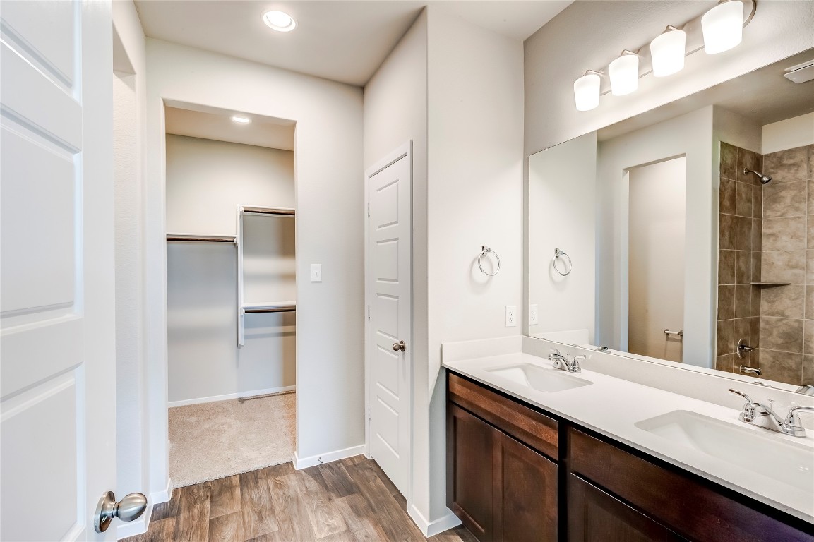 274 Jade Street Maxwell, TX 78656 - Photo 11 of 36 a bathroom with a double vanity sink a mirror and a shower