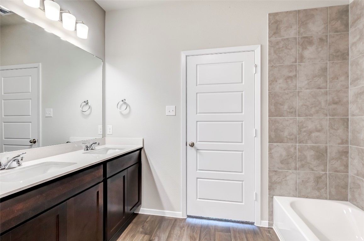 274 Jade Street Maxwell, TX 78656 - Photo 12 of 36 a bathroom with a sink a tub and a mirror