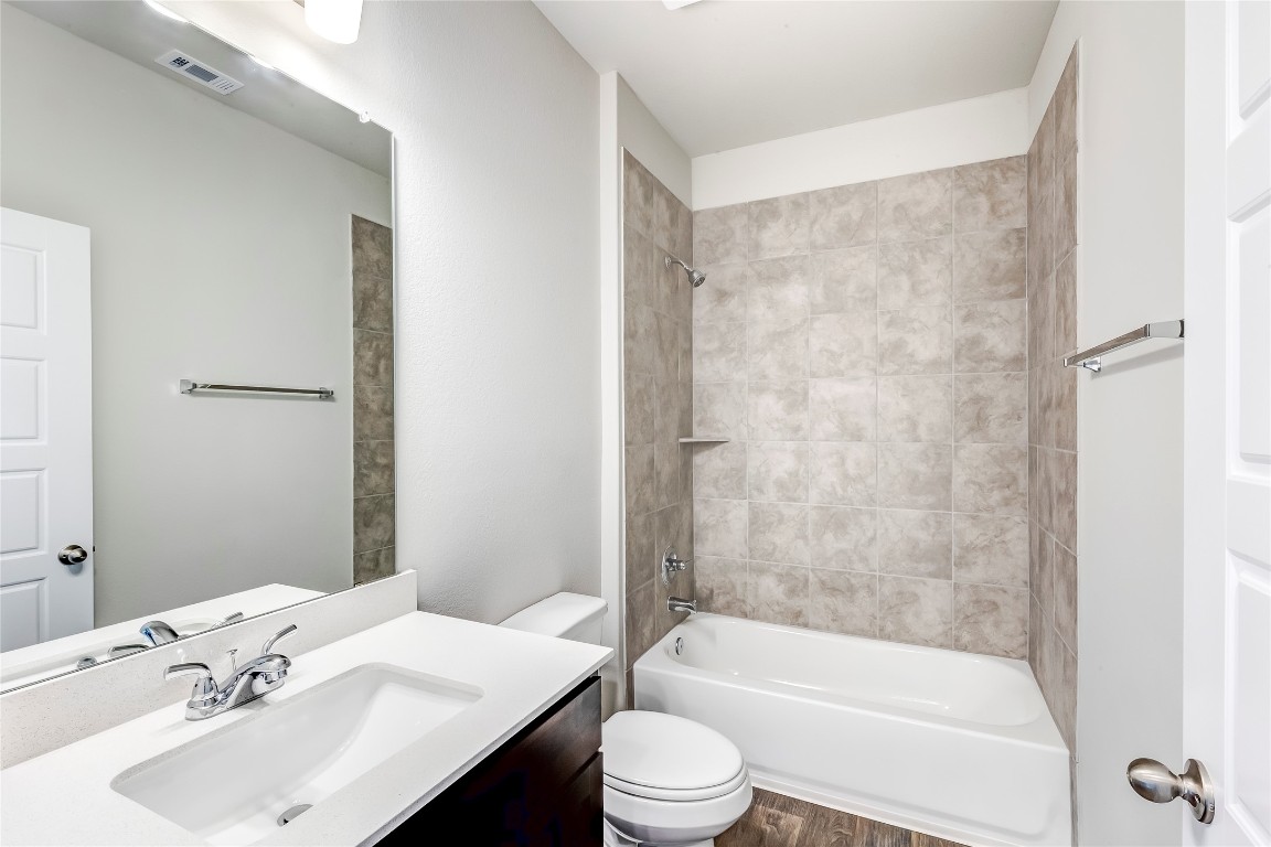 274 Jade Street Maxwell, TX 78656 - Photo 16 of 36 a bathroom with a bathtub shower sink vanity and toilet