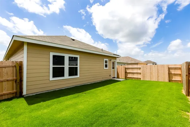 a view of a deck with a big yard and large trees