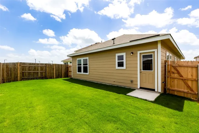 a view of a house with a backyard