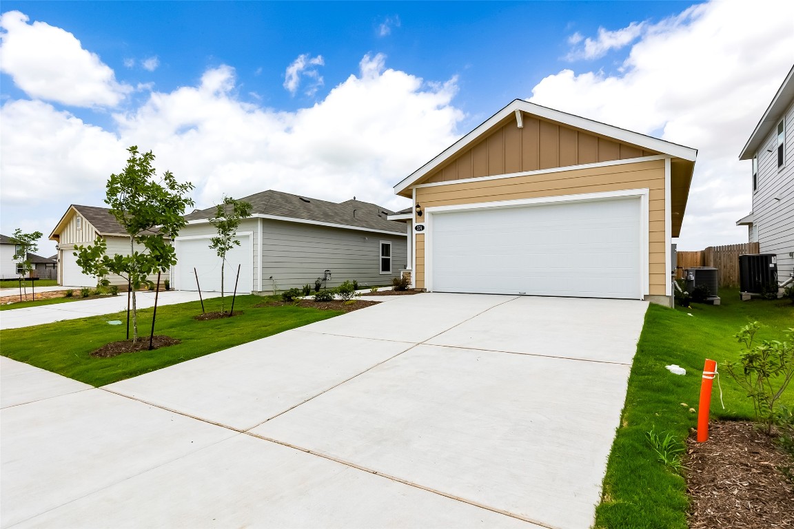274 Jade Street Maxwell, TX 78656 - Photo 25 of 36 a front view of house with garage and yard