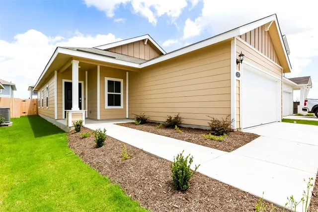 a front view of house with garage and yard