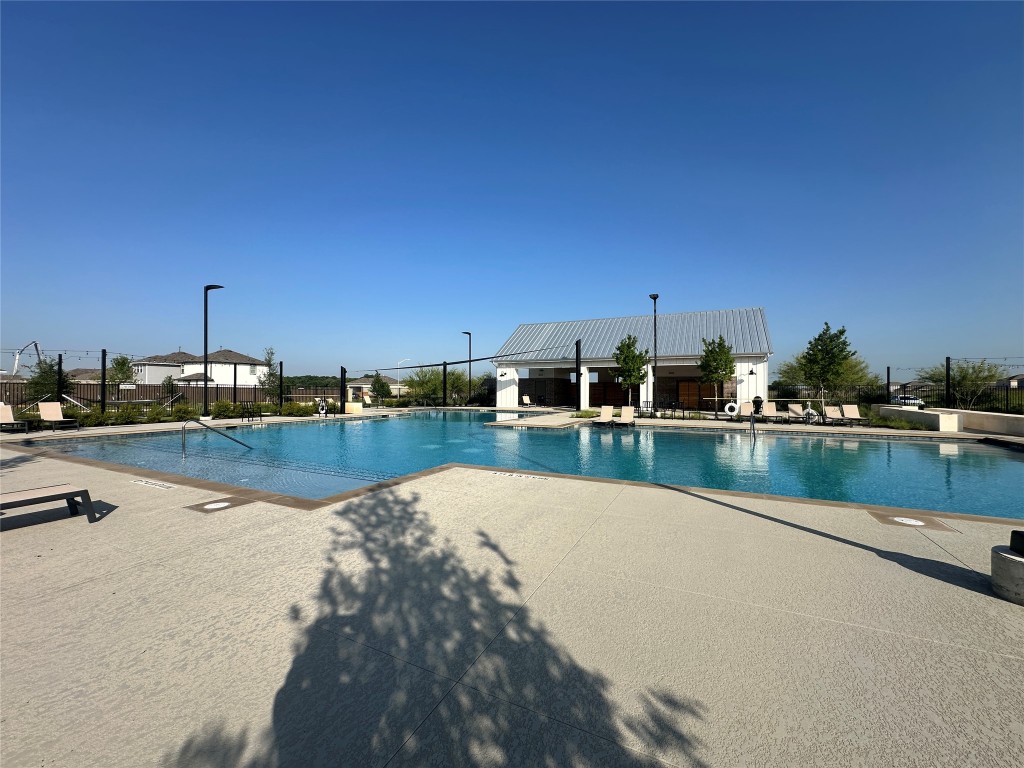 274 Jade Street Maxwell, TX 78656 - Photo 28 of 36 a view of swimming pool with table and chairs under an umbrella