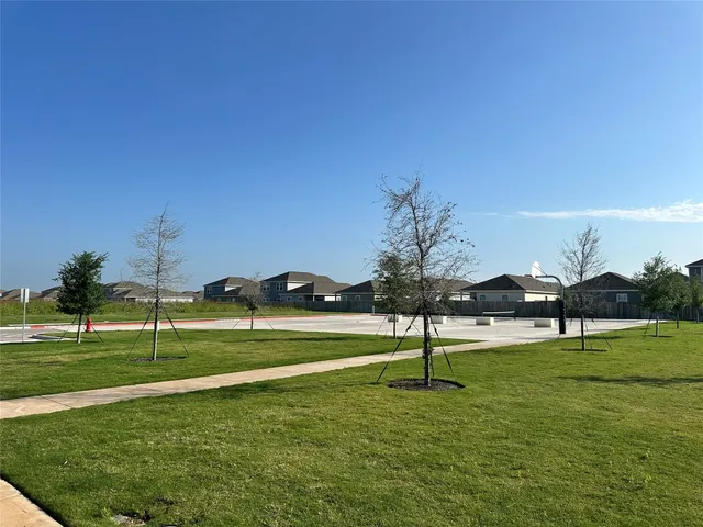 a swimming pool with outdoor seating and yard