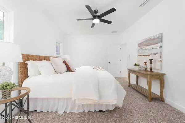a bed room with bed and a chair