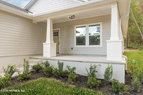 front view of a house with potted plants