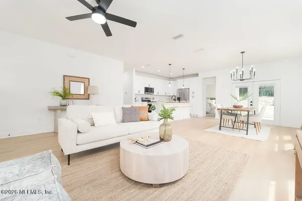 a living room with furniture and a kitchen view