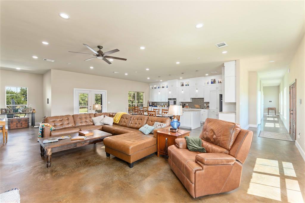 1005 Deep Water Road May, TX 76857 - Photo 14 of 40 Spacious open-concept living area featuring a ceiling fan, recessed lighting, and durable concrete flooring