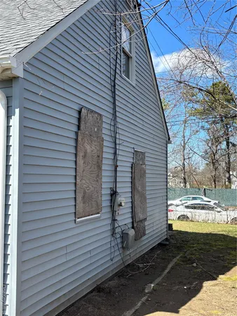 a view of a house with a yard and a tree