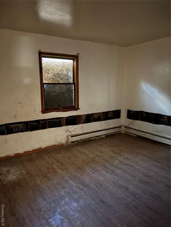 a view of a room with wooden floor and window