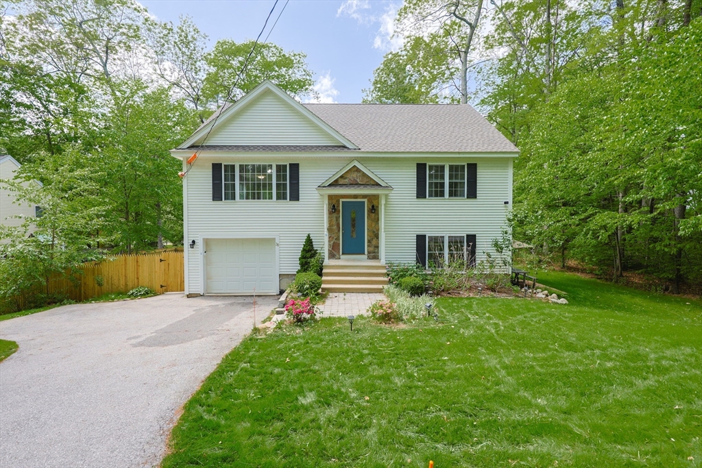 38 Tavern Road Groton, MA 01450 - Photo 1 of 25 a front view of a house with a garden and yard