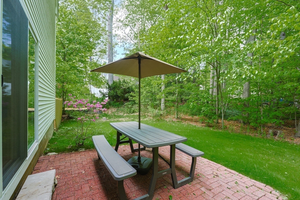 38 Tavern Road Groton, MA 01450 - Photo 21 of 25 a view of a table and chairs under an umbrella