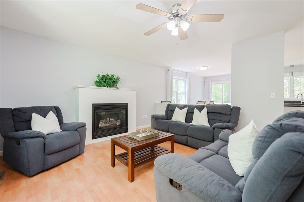 38 Tavern Road Groton, MA 01450 - Photo 3 of 25 a living room with furniture a fireplace and a chandelier