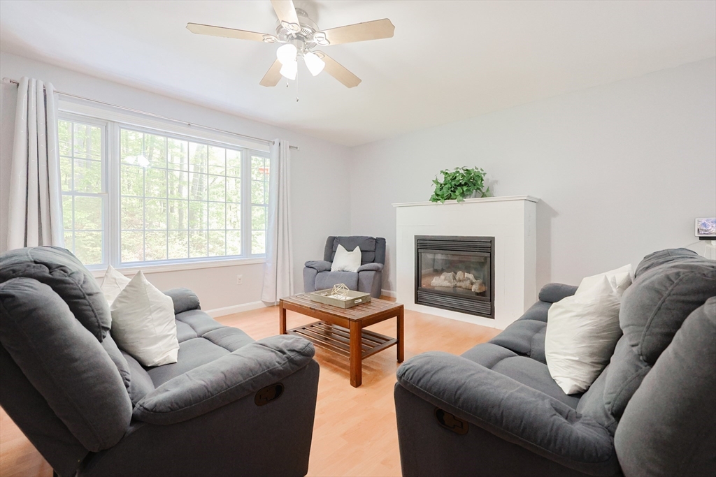 38 Tavern Road Groton, MA 01450 - Photo 4 of 25 a living room with furniture a fireplace and a large window