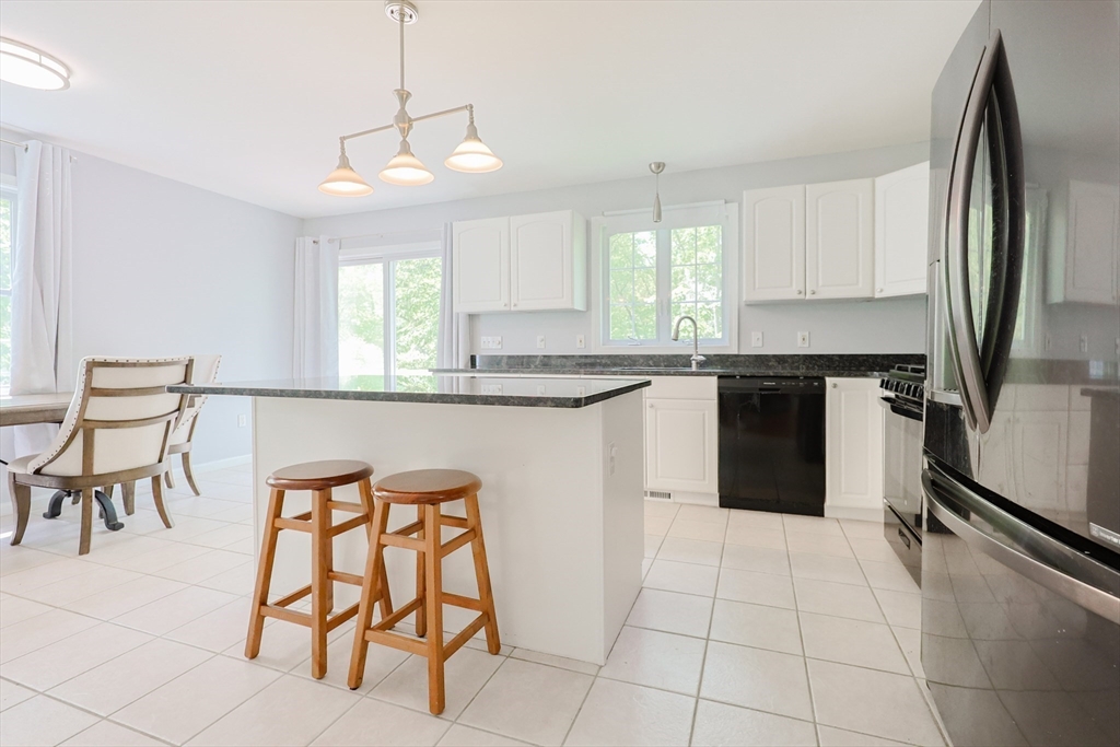 38 Tavern Road Groton, MA 01450 - Photo 6 of 25 a kitchen with stainless steel appliances granite countertop a sink counter space and cabinets