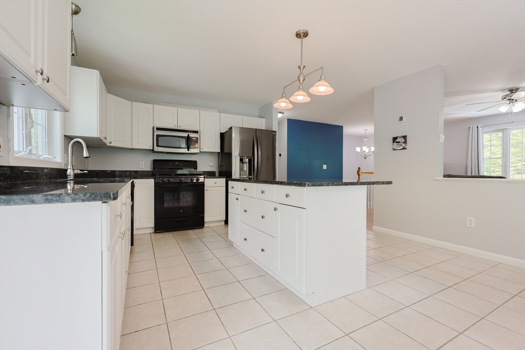 38 Tavern Road Groton, MA 01450 - Photo 7 of 25 a large kitchen with cabinets and stainless steel appliances