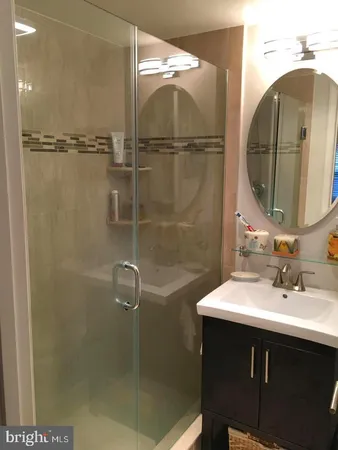 a bathroom with a sink vanity and a mirror