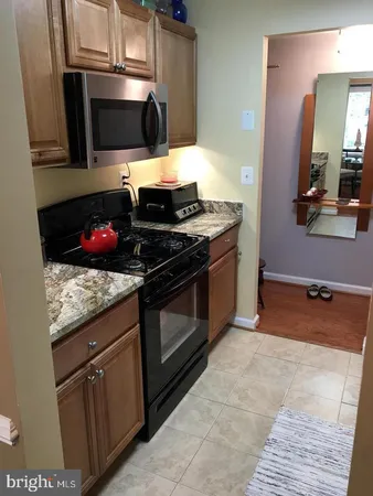 a kitchen with stainless steel appliances granite countertop a stove and a microwave