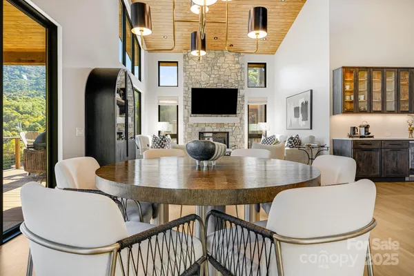 a dining room with furniture a window and a chandelier