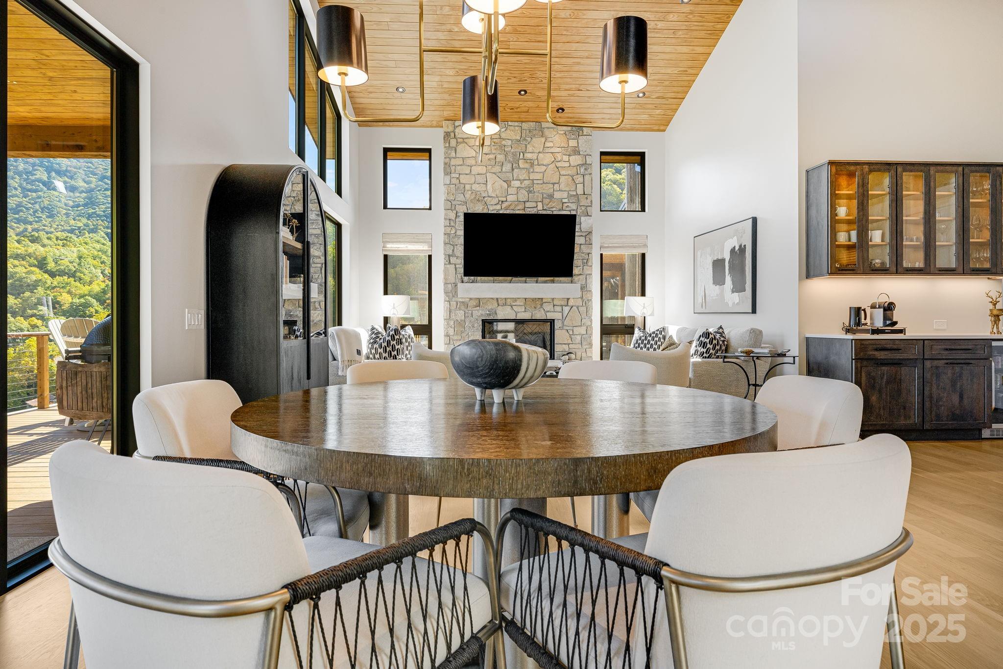 13 Switchgrass Way, Unit 407 Sylva, NC 28779 - Photo 11 of 48 a dining room with furniture a window and a chandelier