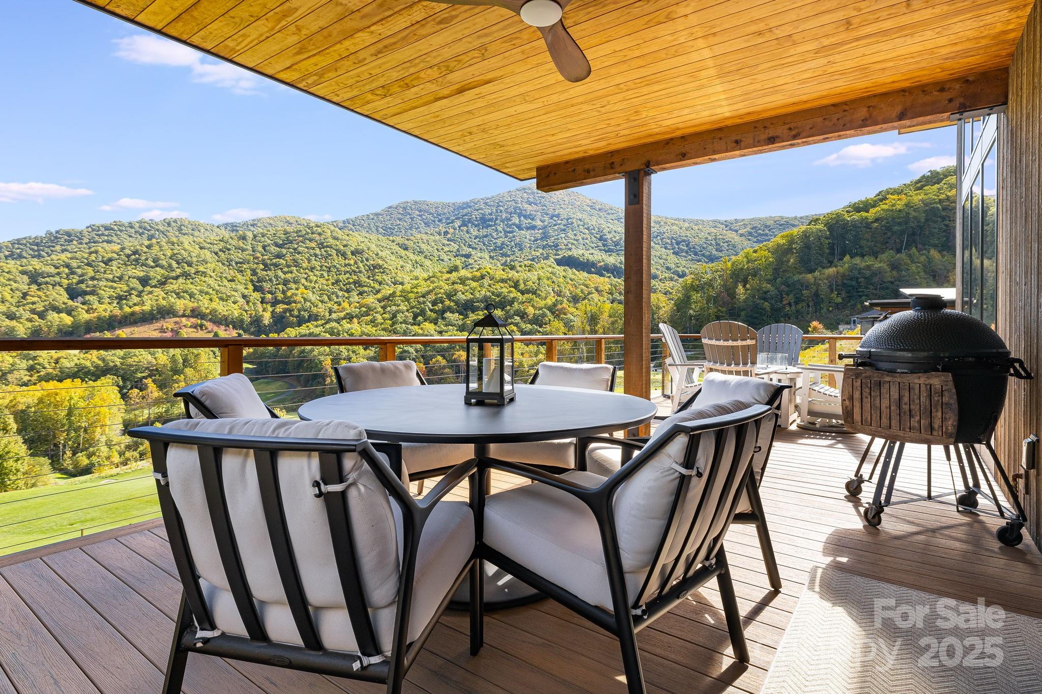 13 Switchgrass Way, Unit 407 Sylva, NC 28779 - Photo 12 of 48 a view of a balcony with chairs and wooden floor