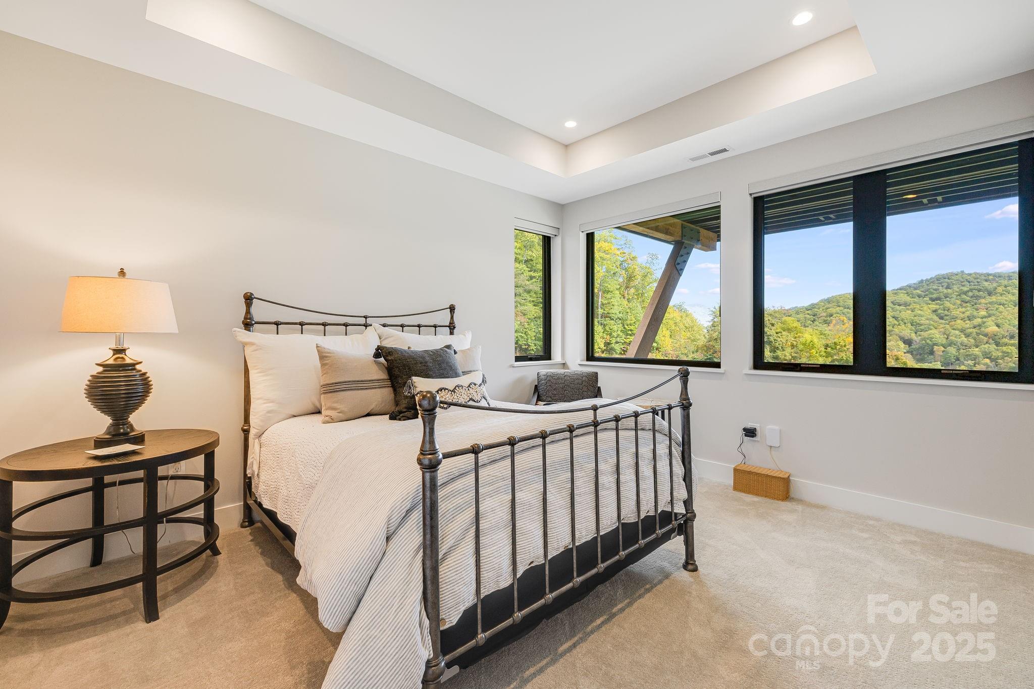 13 Switchgrass Way, Unit 407 Sylva, NC 28779 - Photo 25 of 48 a bedroom with a bed and large windows