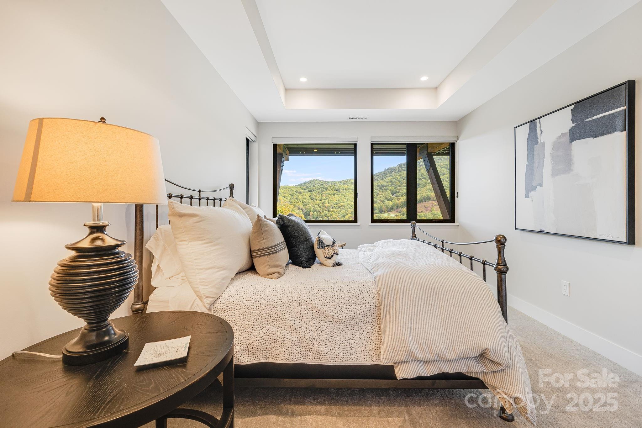 13 Switchgrass Way, Unit 407 Sylva, NC 28779 - Photo 26 of 48 a bedroom with a bed and a chair with the outer view