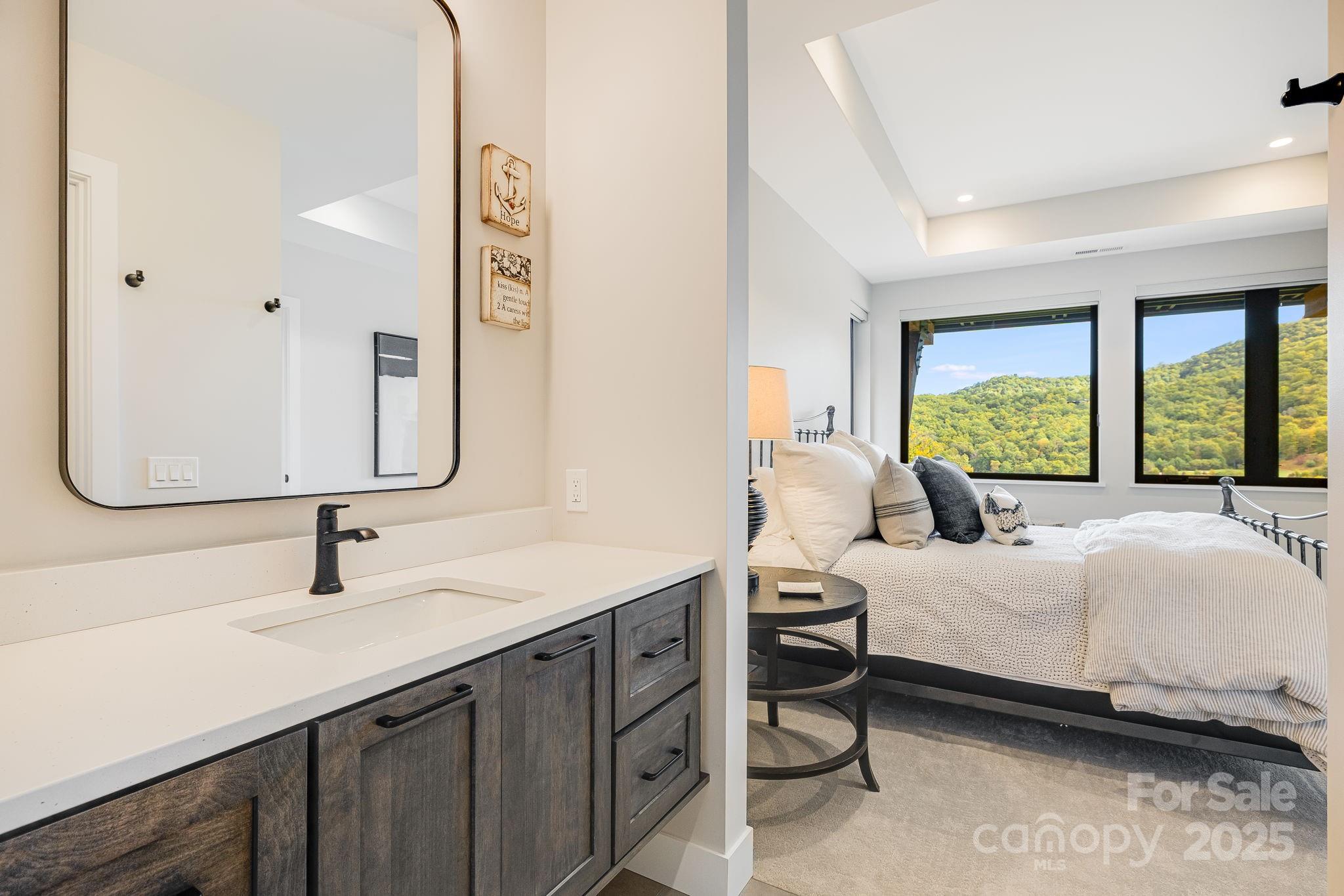 13 Switchgrass Way, Unit 407 Sylva, NC 28779 - Photo 27 of 48 a bedroom with a bed and a large window