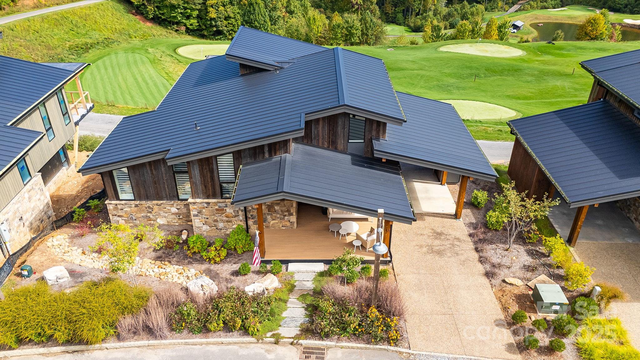 13 Switchgrass Way, Unit 407 Sylva, NC 28779 - Photo 40 of 48 a front view of a house with garden