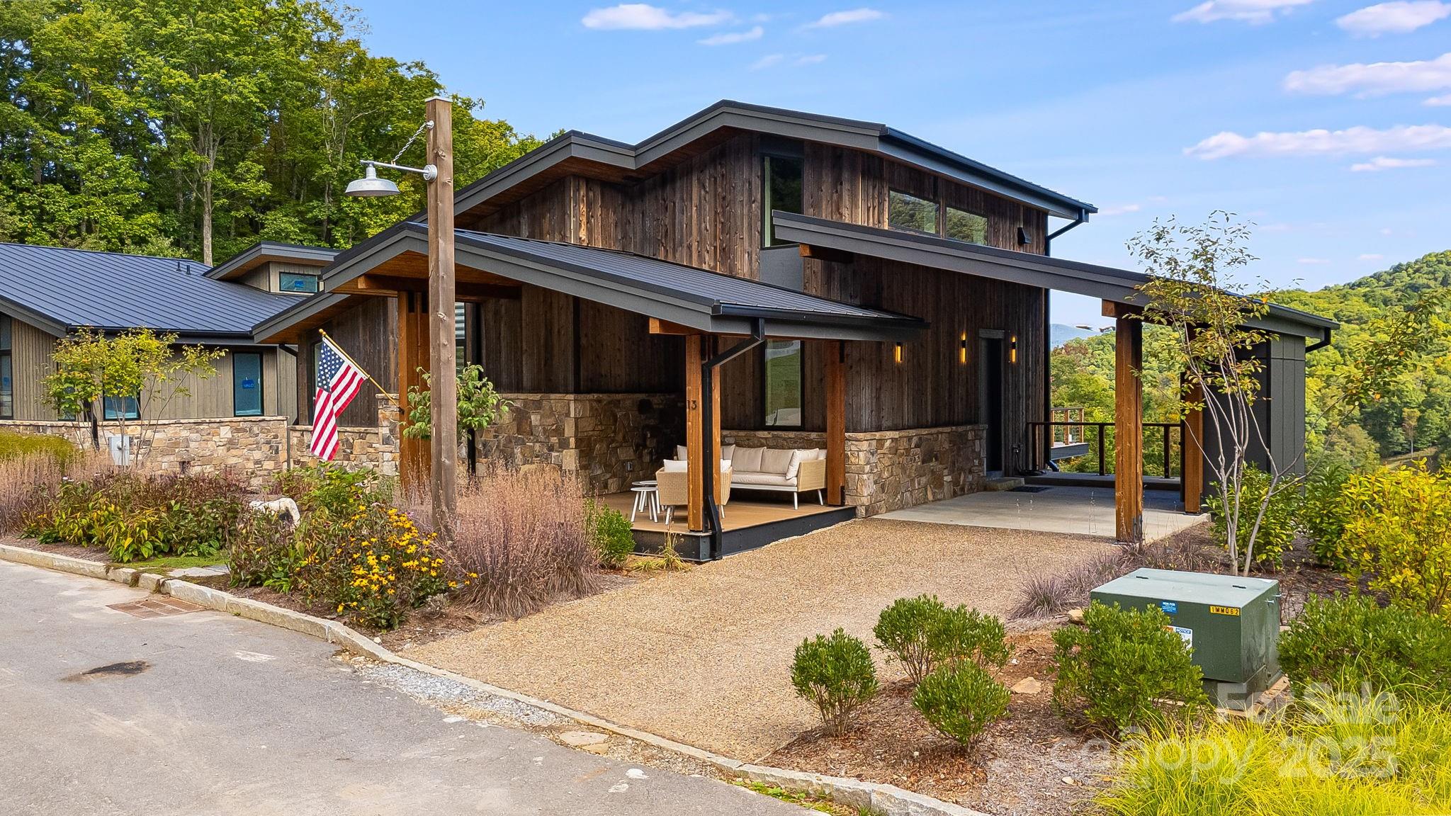 13 Switchgrass Way, Unit 407 Sylva, NC 28779 - Photo 41 of 48 a front view of a house with garden