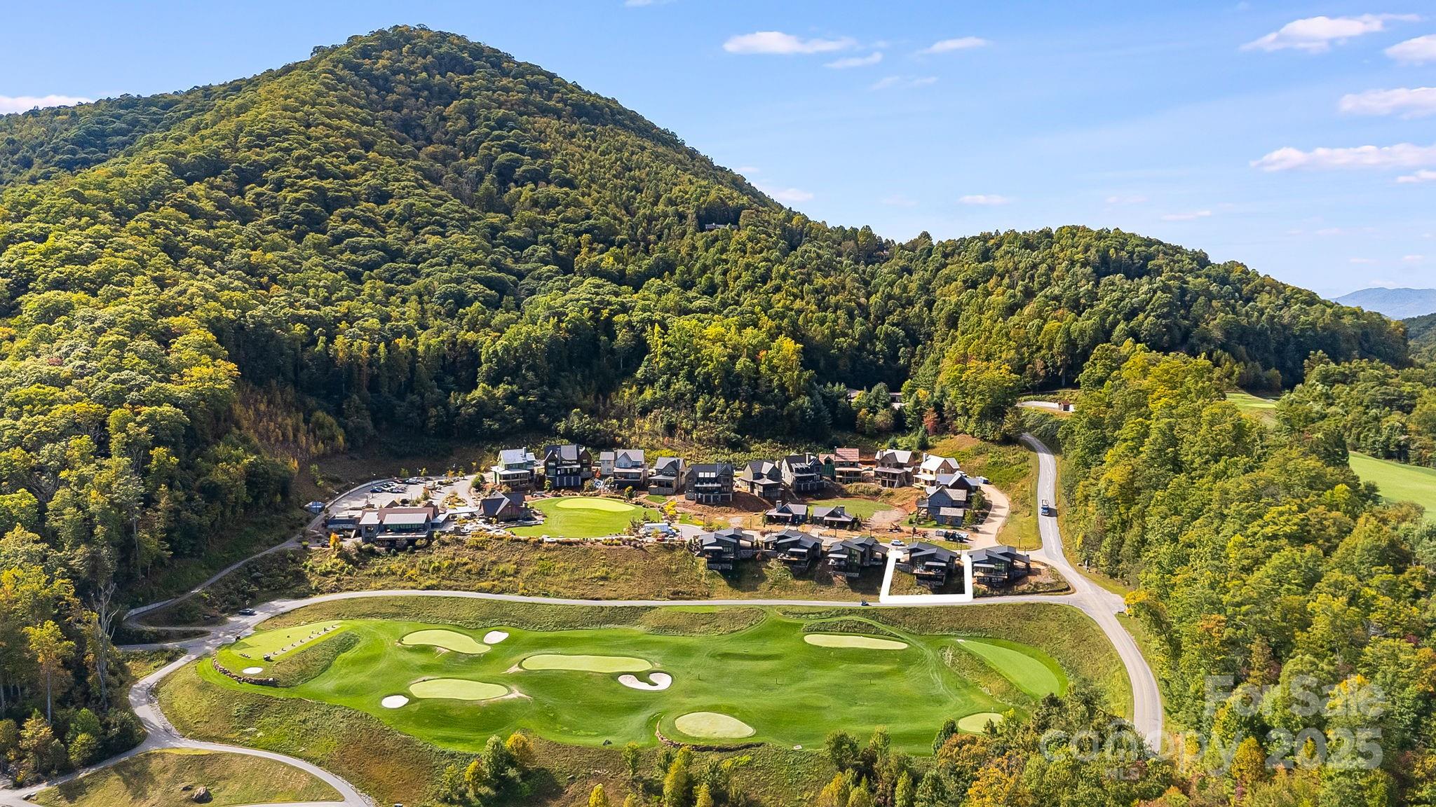 13 Switchgrass Way, Unit 407 Sylva, NC 28779 - Photo 42 of 48 a view of a swimming pool with a yard