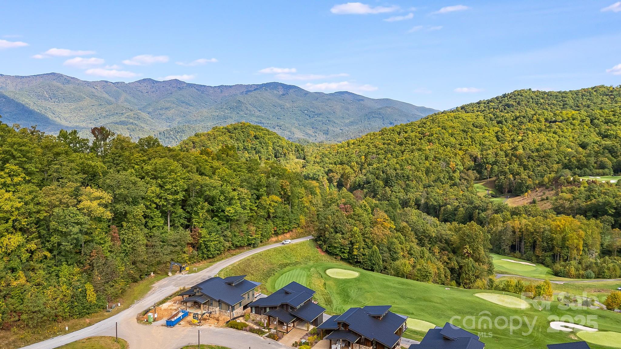 13 Switchgrass Way, Unit 407 Sylva, NC 28779 - Photo 44 of 48 an aerial view of a house with a yard