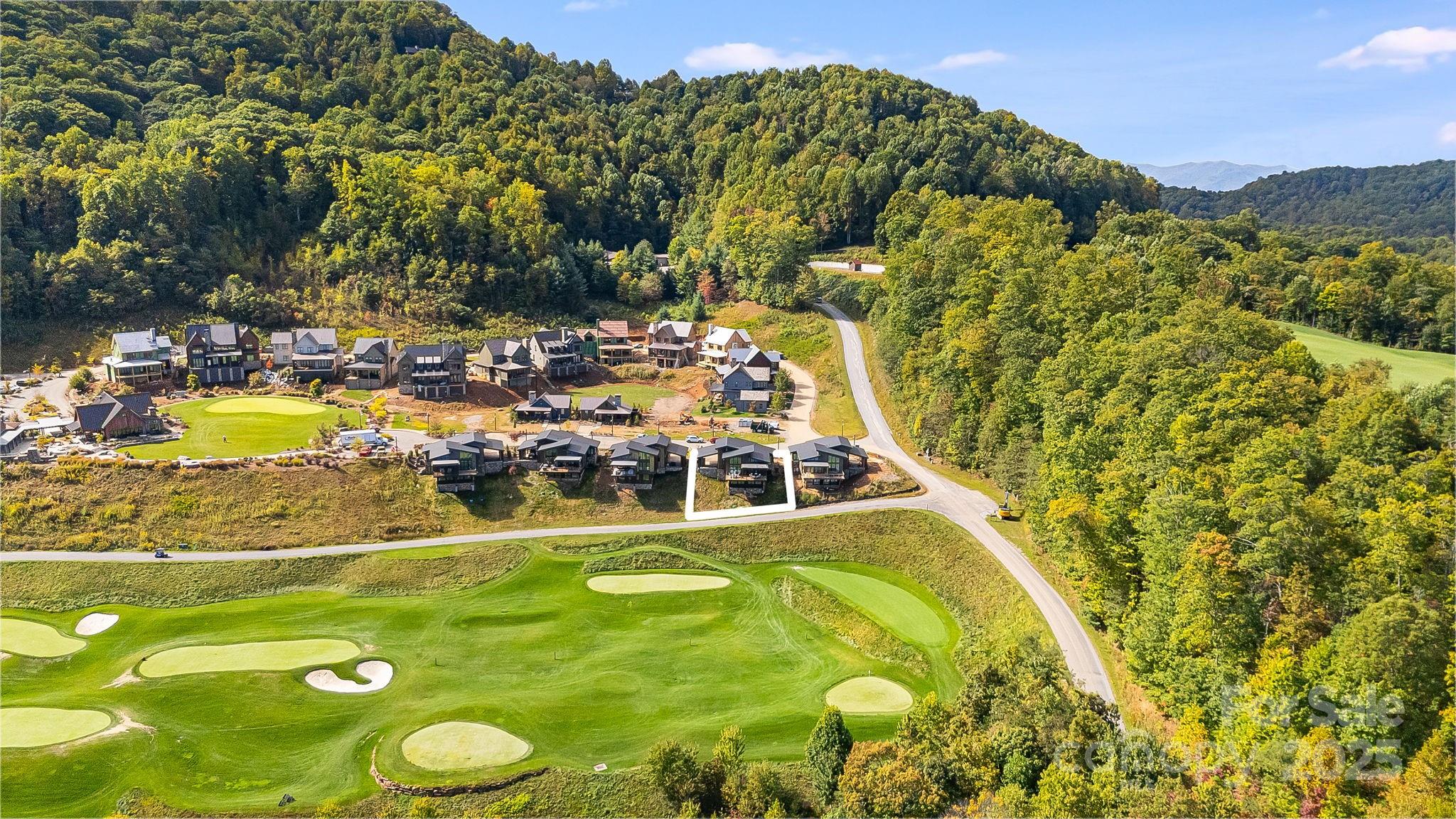 13 Switchgrass Way, Unit 407 Sylva, NC 28779 - Photo 45 of 48 a view of a swimming pool with a yard