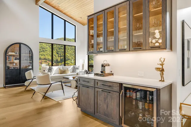 a living room with a large window and furniture