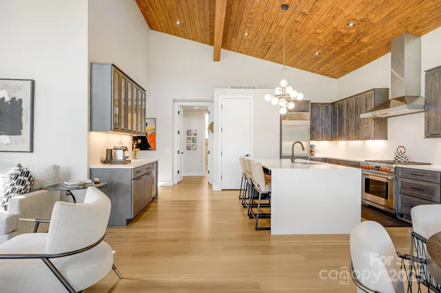 a living room with stainless steel appliances kitchen island granite countertop furniture and a kitchen view