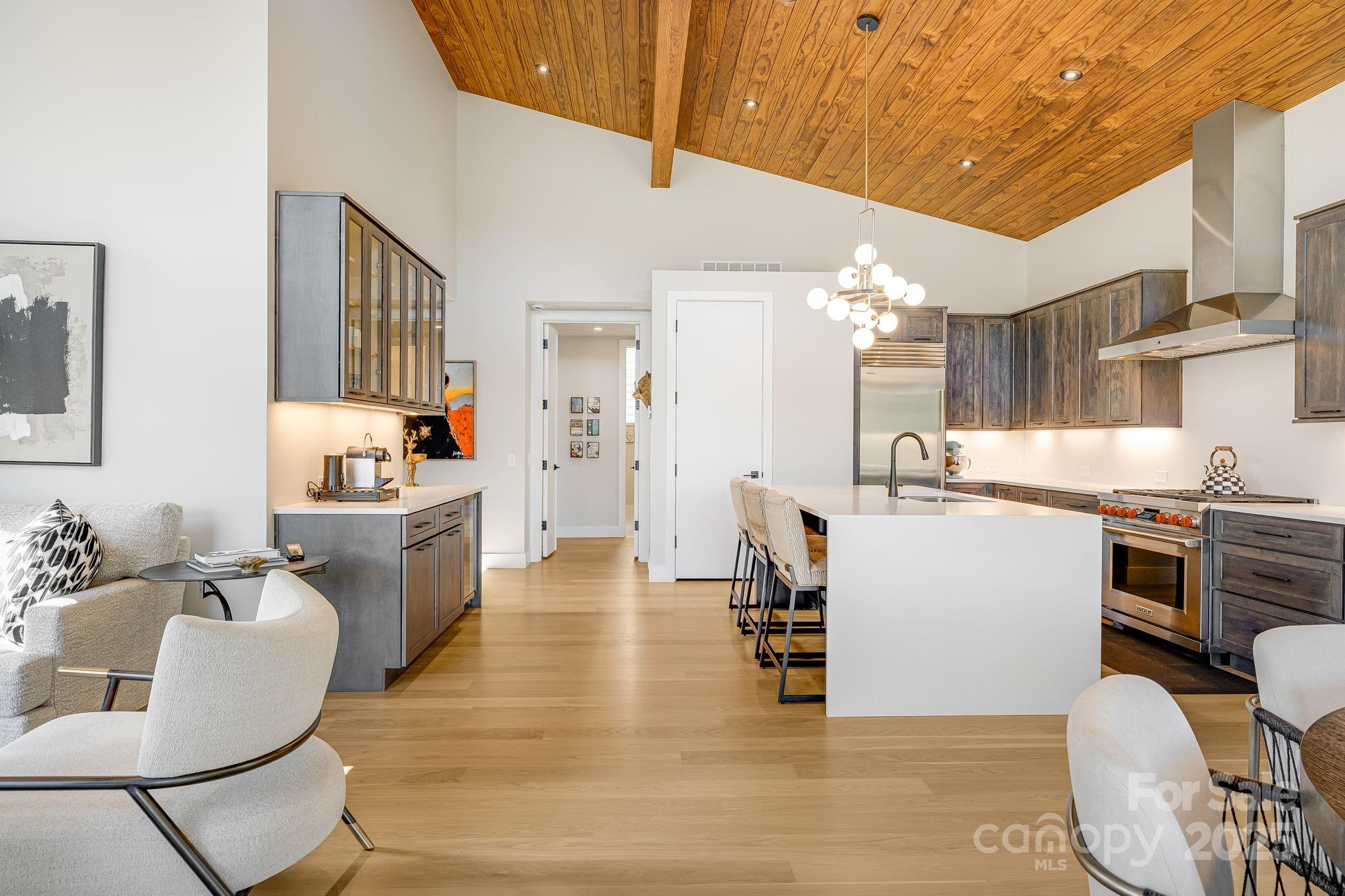 13 Switchgrass Way, Unit 407 Sylva, NC 28779 - Photo 9 of 48 a living room with stainless steel appliances kitchen island granite countertop furniture and a kitchen view