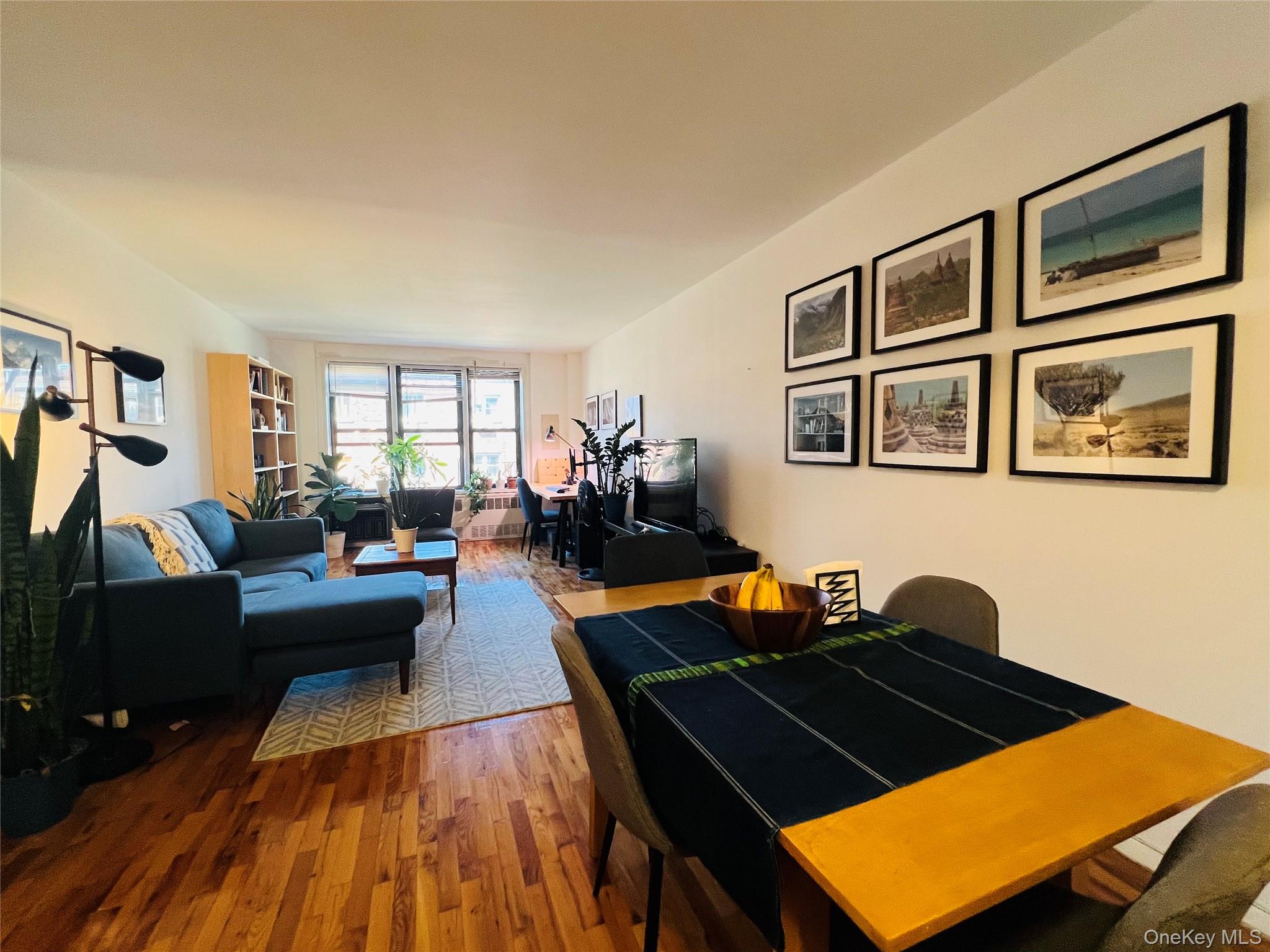 58-03 Calloway Street, Unit 3MM Queens, NY 11368 - Photo 5 of 9 a living room with furniture rug and wooden floor
