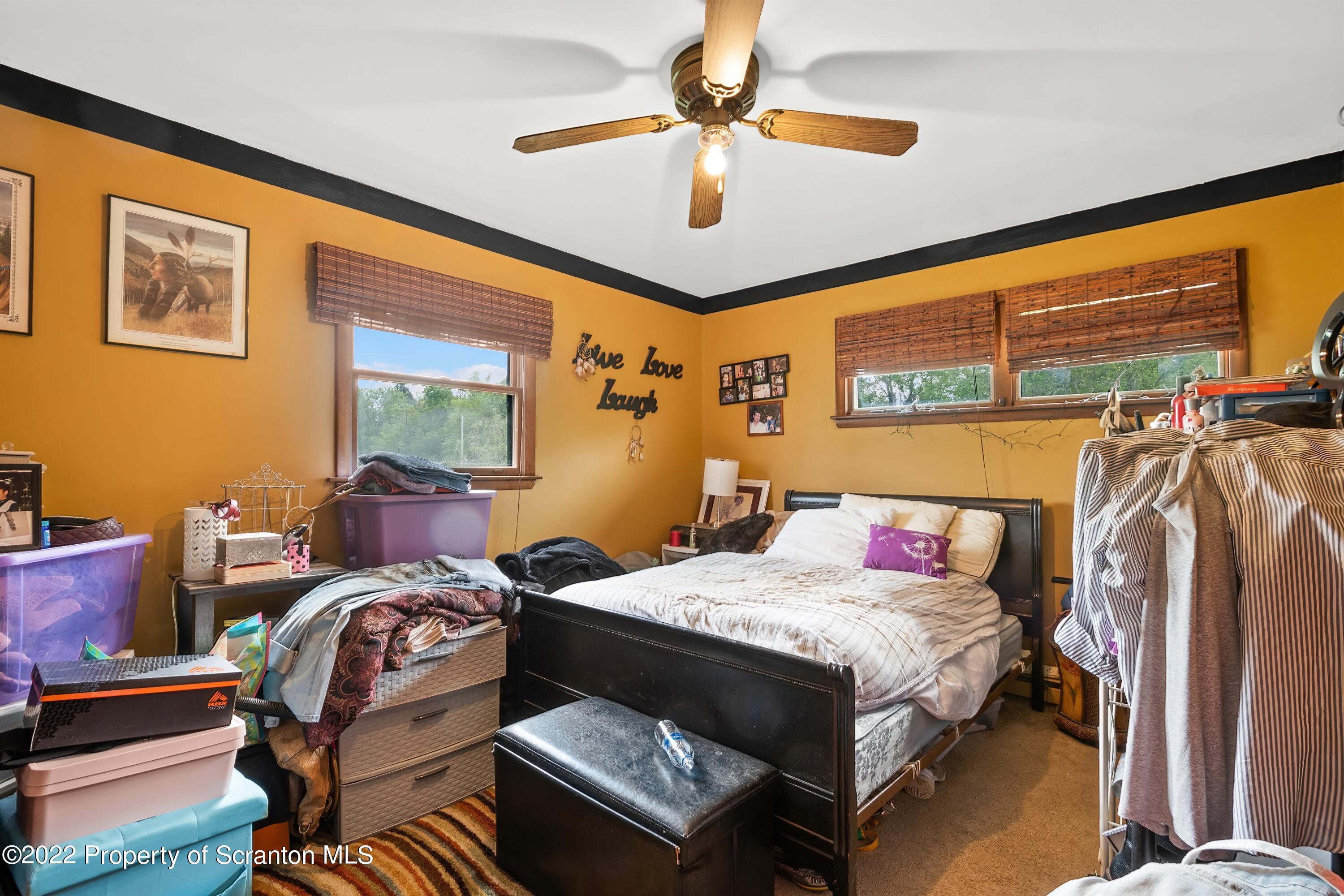 116 Hack Road Dalton, PA 18414 - Photo 22 of 33 a bedroom with a bed couch and a window