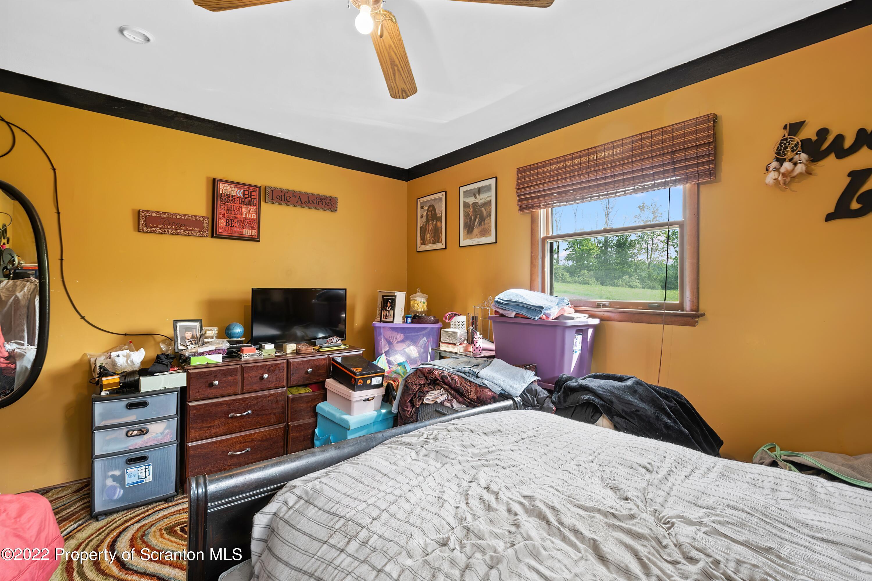 116 Hack Road Dalton, PA 18414 - Photo 23 of 33 a bedroom with a bed and wooden floor