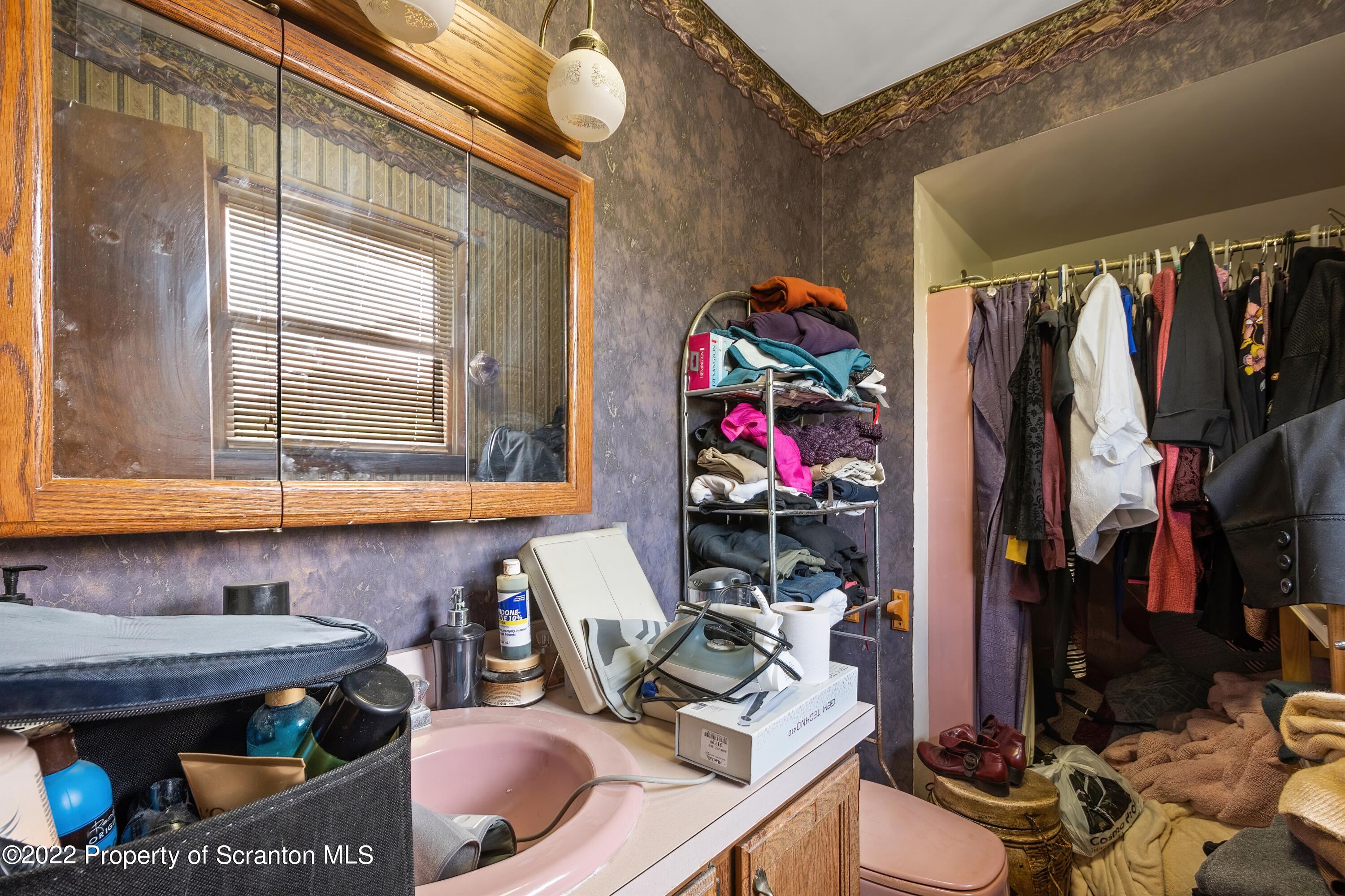 116 Hack Road Dalton, PA 18414 - Photo 24 of 33 a view of walk in closet with clothes and shoes